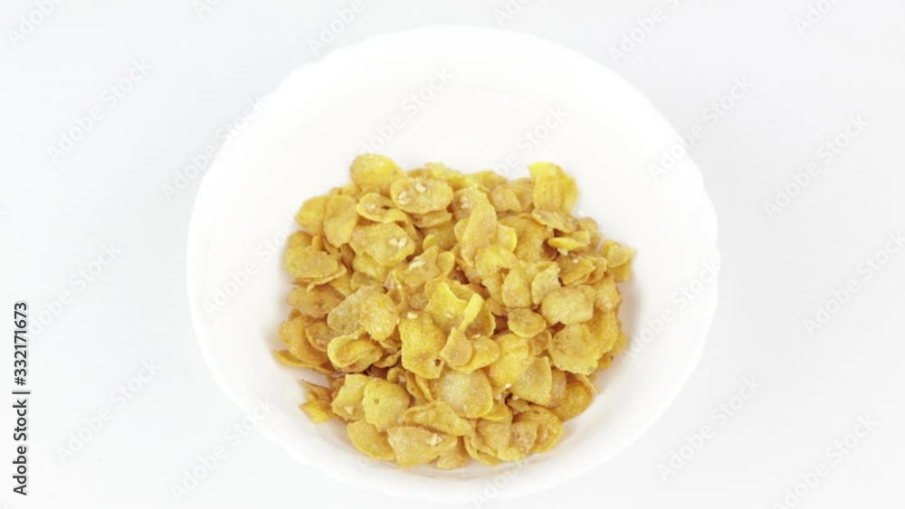 white plate is filled with cornflakes and filled with milk, a healthy food concept white plate is filled with cornflakes and filled with milk, a healthy food concept