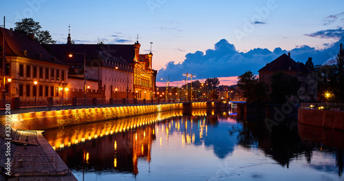 The promenade of Wroclaw - European Capital of Culture, view from river Odra, after sunset at night. Poland, Europe.