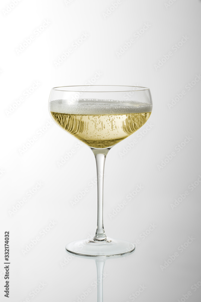 Glass cup with sparkling wine with foam Glass cup with sparkling wine with foam