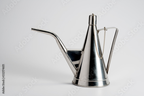Steel oil cruet on white background