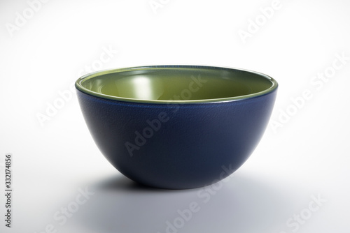 Empty blue and green bowl on the white background