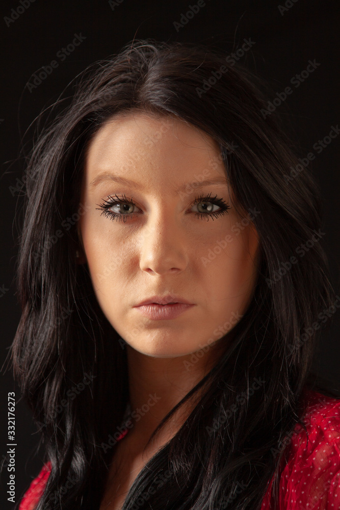 Fototapeta premium Low key portait of a pretty young woman