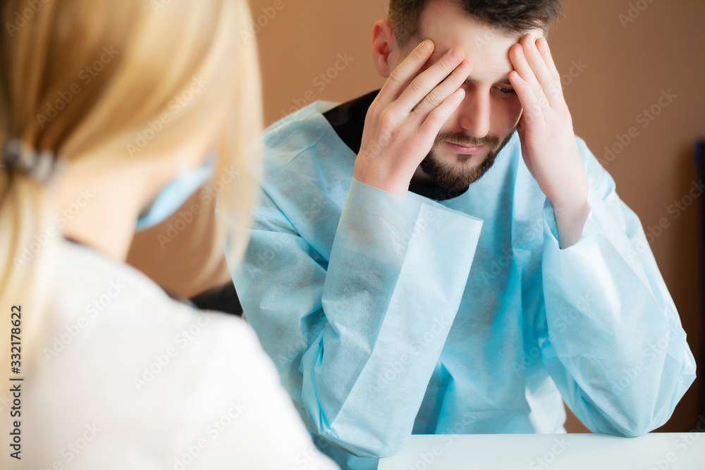 Man learns about the disappointing diagnosis in the doctor's office. Man learns about the disappointing diagnosis in the doctor's office.