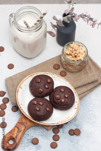 Chocolate chip cookies with glass of milk on gray background photo