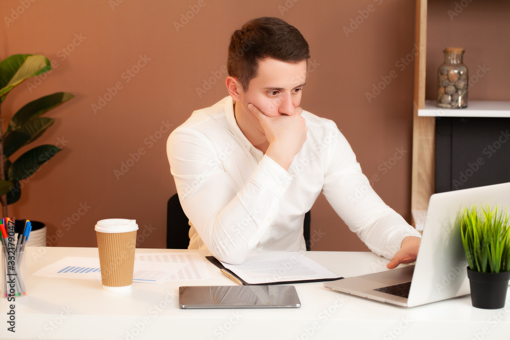 Tired man working at the computer in the office. Tired man working at the computer in the office.