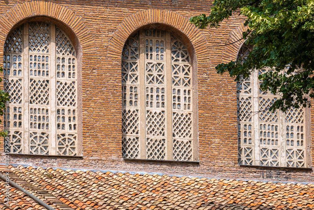 Fototapeta premium old bricks church with beautiful windows