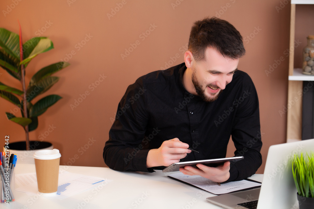 Successful businessman working in the office at the computer. Successful businessman working in the office at the computer.