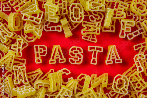 Letter pasta in red background.