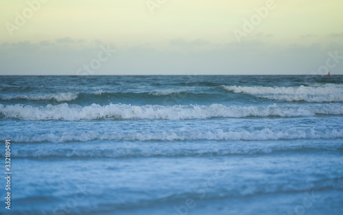 blur sea waves on sky background in selective focus