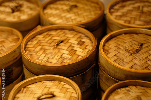 close up stack of food steamer (made of bamboo). Chinese cuisine culture concept. Blur background