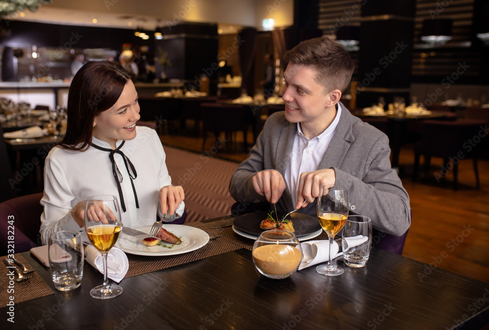 young caucasian married couple have conversation in restaurant. man and woman came to celebrate their anniversary, happy couple in luxury restaurant. romantic place for rendezvous