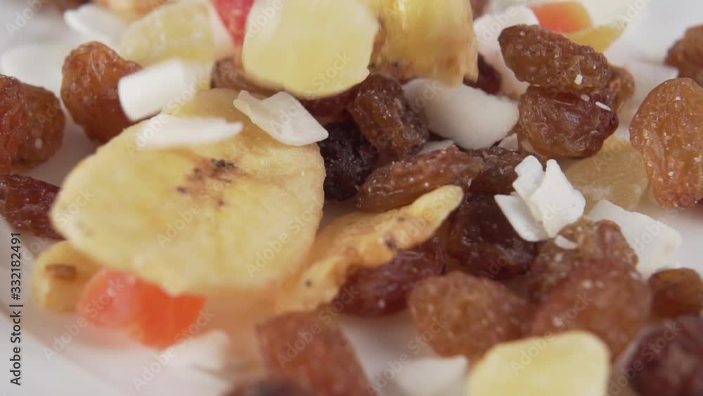 mix of dried fruit fills a white cup. Slow motion. Macro shot mix of dried fruit fills a white cup. Slow motion. Macro shot