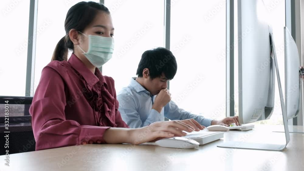 Employee man cough without mask and woman working together look with concern coronavirus(covid-19) outbreak that man put on mask. Employee man cough without mask and woman working together look with concern coronavirus(covid-19) outbreak that man put on mask.