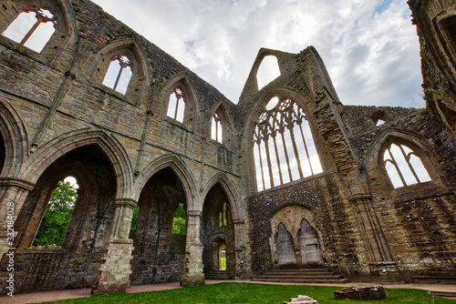 The ruins of Tintern Abbey, founded by Walter de Clare, Lord of Chepstow, on 9 May 1131. It is situated adjacent to the village of Tintern in Monmouthshire, Wales, UK. photo