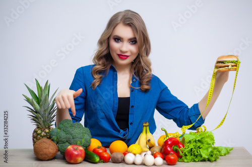 Cute woman makes a choice between healthy and harmful food