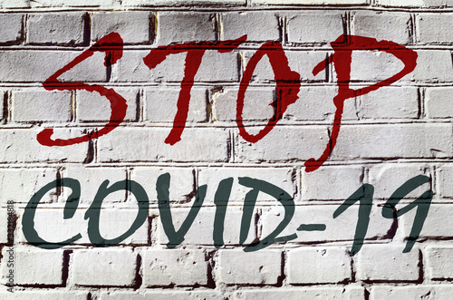 Abstract image with the inscription on the wall "Stop COVID-19!!!"