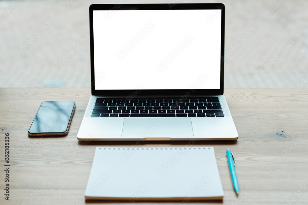 smartphone, blank notebook, pen and laptop on wooden table smartphone, blank notebook, pen and laptop on wooden table