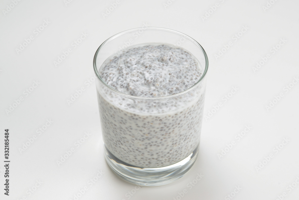 Chia pudding in glass on a white background. Space for text or design. Chia pudding in glass on a white background. Space for text or design.