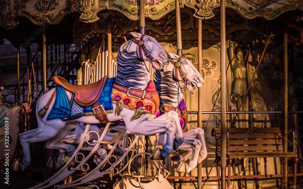 Vibrant horses on a traditional carousel in Montmartre, Paris, France