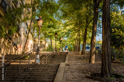 Obraz na płótnie The famous steps of Montmartre, shaded by trees in the early morning sunlight, Paris, France w salonie