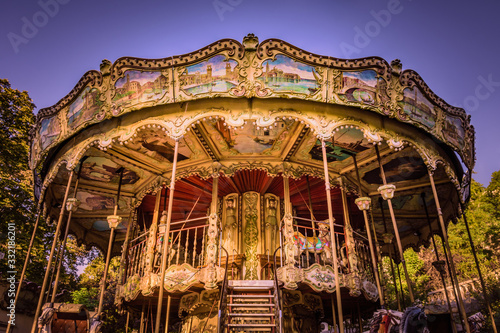 Ornate traditional carousel on a sunny morning in Montmartre, Paris, France