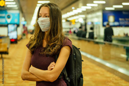travel woman in mask in airport Flight delay/flight cancellation airspace is closed because corona virus epidemic