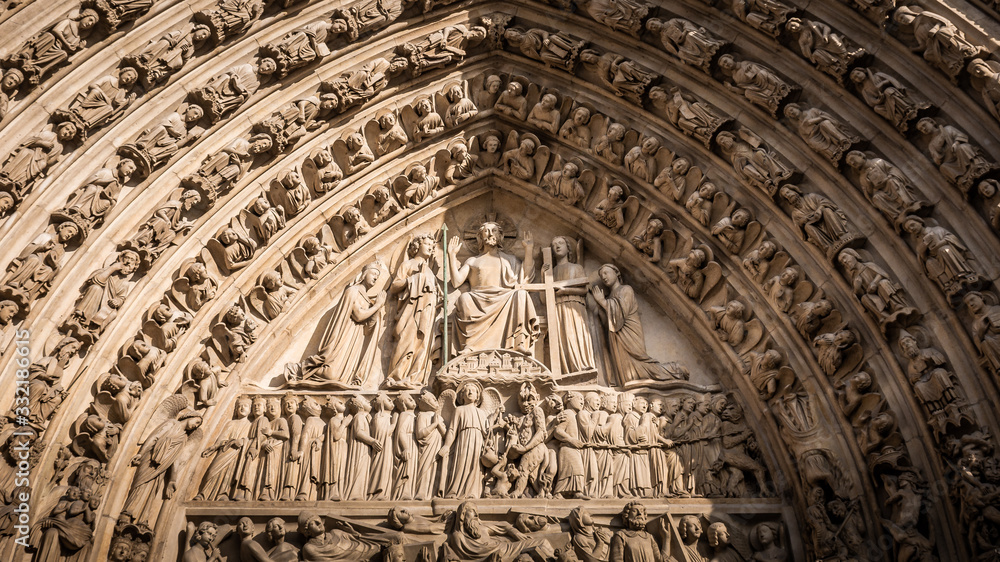 Detail of the main arch on the west facade of Notre Dame Cathedral, Paris, France. Taken on a warm and sunny afternoon in the Autumn