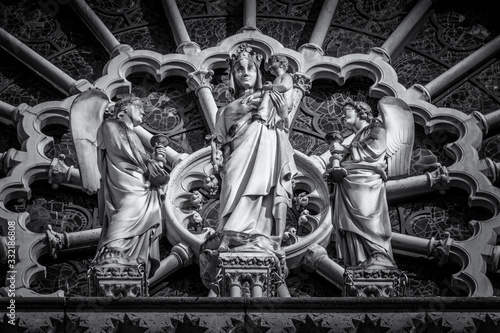 Detail of the Virgin with Child statue, in black and white, on the west facade of Notre Dame Cathedral, Paris, France