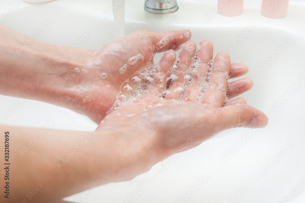 Fototapeta premium Washing hands with soap and water. Antibacterial protection and self-care. Stop the spread of infection.