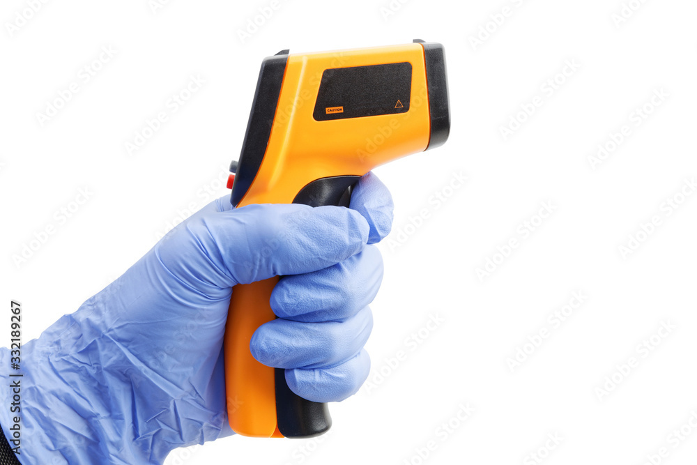 Closeup hand in a blue medical glove holds an digital infrared thermometer. Isolated on white background. Closeup hand in a blue medical glove holds an digital infrared thermometer. Isolated on white background.
