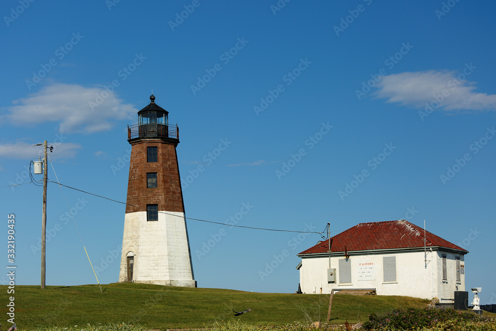 Point Judith Lighthouse on a sunny late afternoon at Narragansett, RI, USA. The lighthouse  is located on the west side of the entrance to Narragansett Bay.