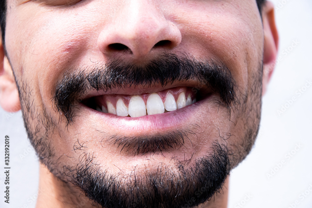 portrait of a young man showing his teeth portrait of a young man showing his teeth