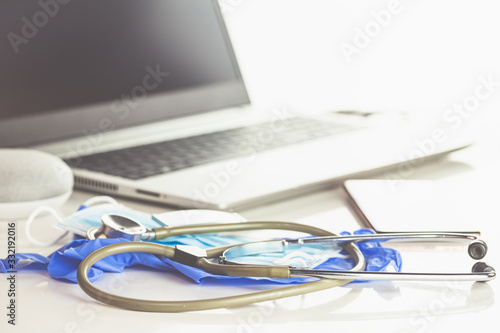 Home Office Medizin - PC mit Maske  Stethoskop  Schutz gegen Virus  Infektion  Handy und Sprachassistent. 