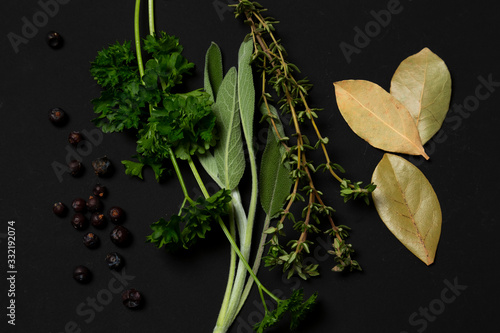 Sage, parsley, thyme, laurel, juniper, herbs on a black background. minimalistic, modern, with copy space