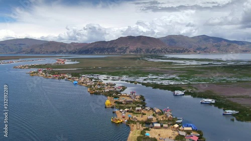 Aerial view of Uros Floating Islands (Spanish: Islas Uros ) on Lake Titicaca, the highest navigable lake in the world, on the border of Peru and Bolivia, South America.
