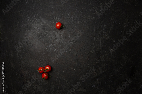 Cherry tomatos on black background