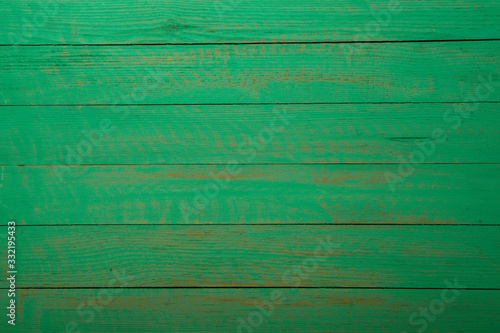 Vintage green wood background texture with knots and nail holes. Old painted wood wall. Brown abstract background. Vintage green wooden dark horizontal boards. Front view with copy space. Background f
