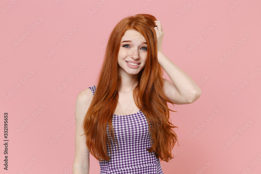 Preoccupied young redhead woman girl in plaid dress posing isolated on pastel pink wall background studio portrait. People sincere emotions lifestyle concept. Mock up copy space. Put hand on head. Preoccupied young redhead woman girl in plaid dress posing isolated on pastel pink wall background studio portrait. People sincere emotions lifestyle concept. Mock up copy space. Put hand on head.