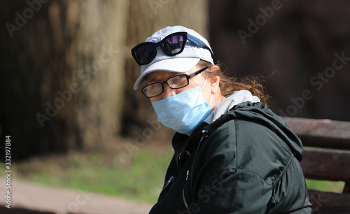 woman in medical mask from coronavirus outdoors