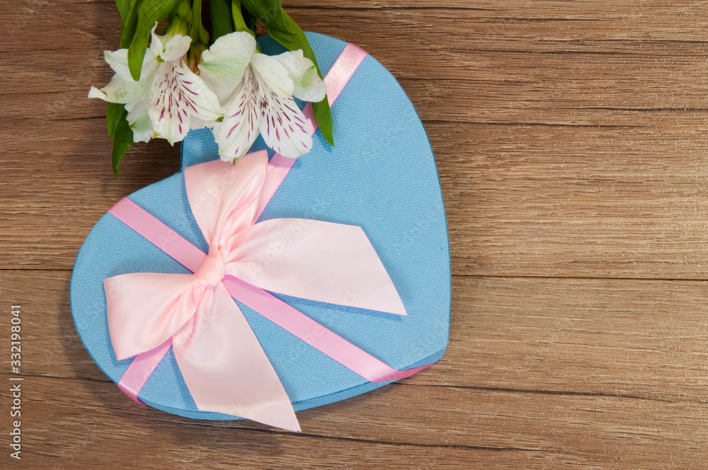 Heart box with beautiful flowers on wooden background. Heart box with beautiful flowers on wooden background.