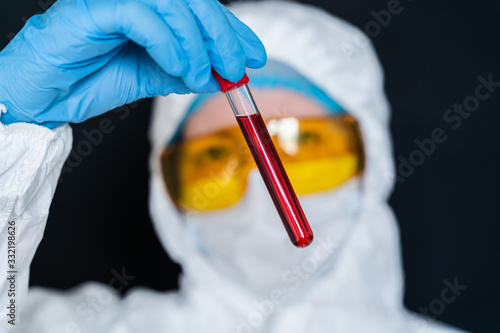 Nurse holding test tube with Positive Coronavirus test blood sample. 2019-nCoV pandemic, Novel Chinese Coronavirus, Wuhan Coronavirus blood analysis concept.