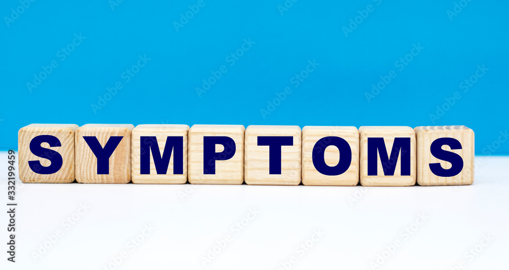 concept word SYMPTOMS on cubes on a blue background concept word SYMPTOMS on cubes on a blue background