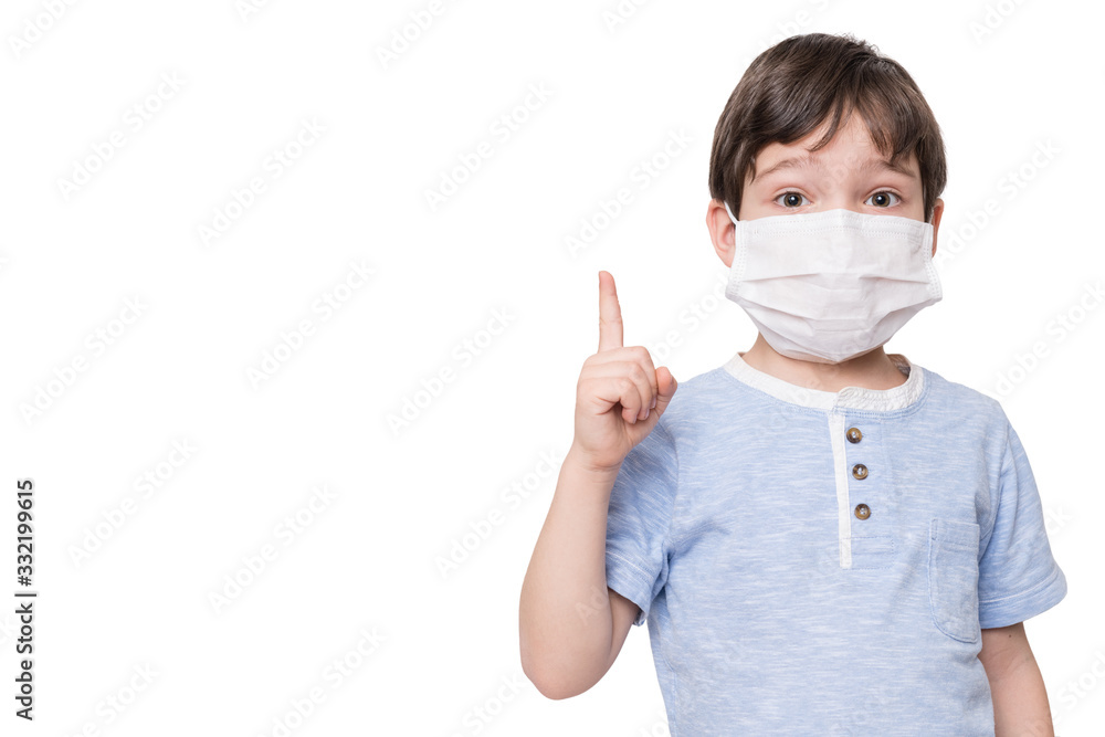 Portrait of kid with face mask pointing finger up, isolated on white background Portrait of kid with face mask pointing finger up, isolated on white background