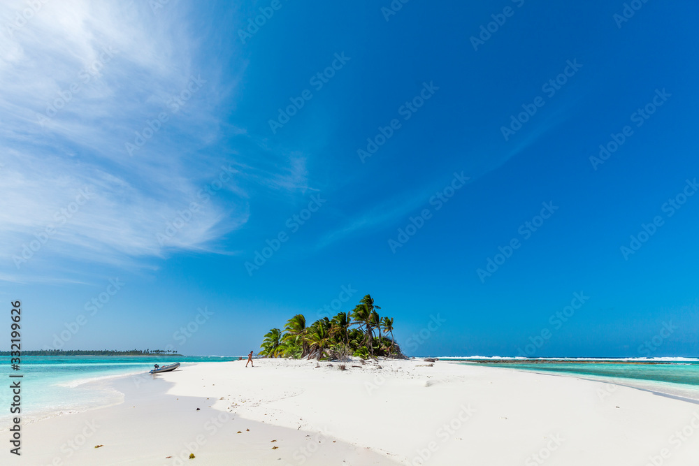 tiny little sandy island with palm tree and white sand beach in the turquoise lagoon of Cocos Keeling atollm landscapephotography