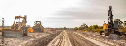 A new road is under construction with several pieces of heavy equipment photo