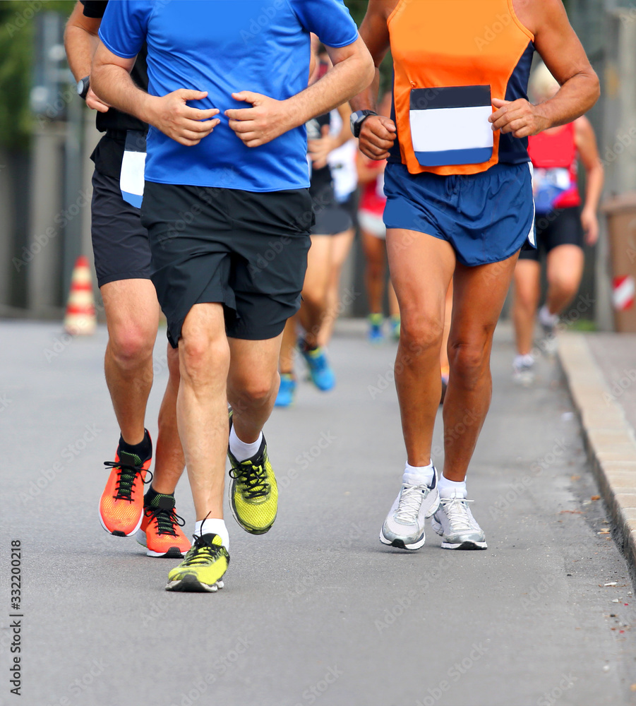 runners with shorts and sneakers on the road runners with shorts and sneakers on the road