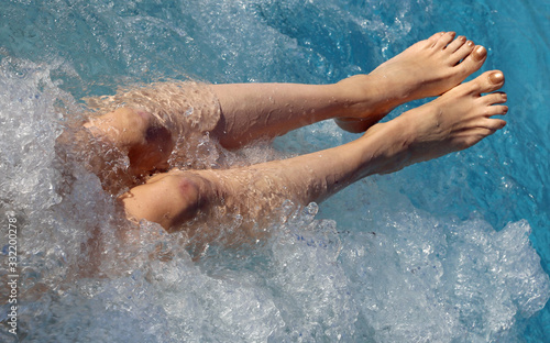 Long legs on woman in the pool