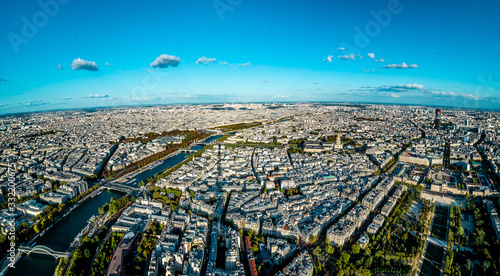 Aerial cityscape of Paris taken from the top of the Eiffel Tower at a sunny afternoon © Csomos