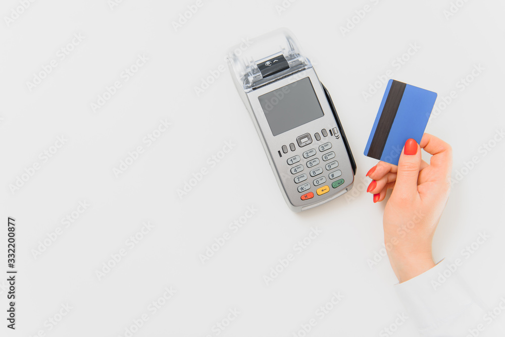 Close up of hand using credit card swiping machine to pay. credit card payment through a shopping terminal. Credit card payment for new clothing collection Close up of hand using credit card swiping machine to pay. credit card payment through a shopping terminal. Credit card payment for new clothing collection