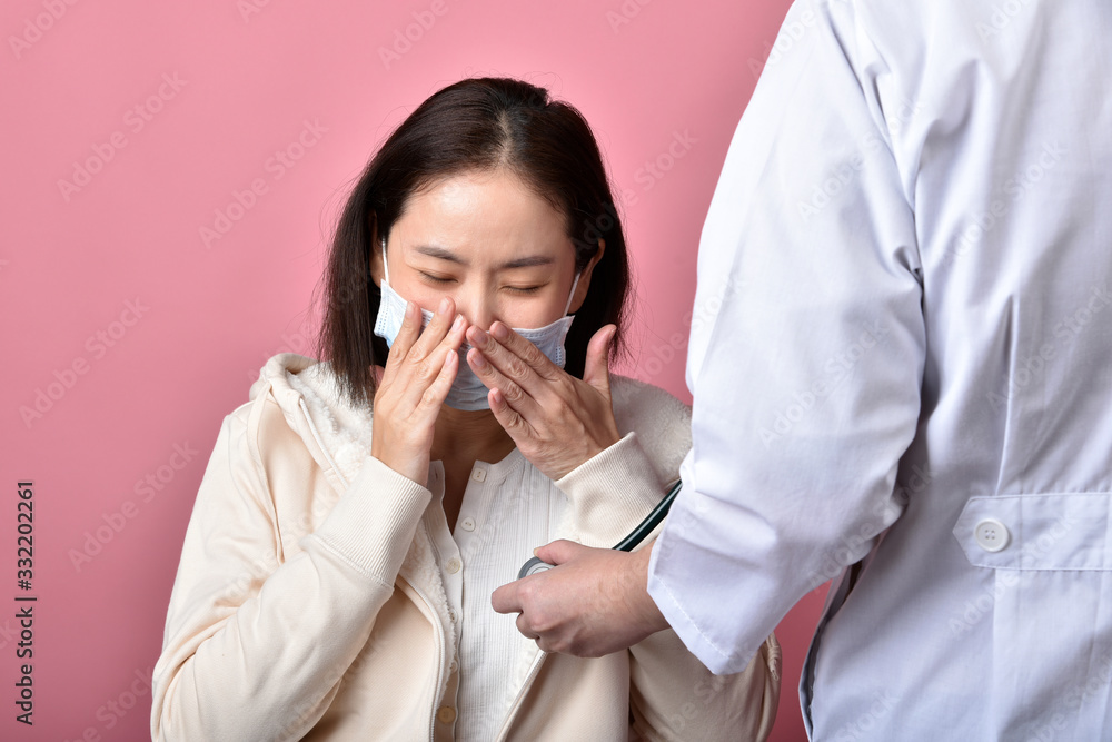 Asian woman have sore throat allergy and coughing in face mask, Sneezing and coughing spread coronavirus disease droplet, Doctor screening covid-19 infected patient in hospital. Asian woman have sore throat allergy and coughing in face mask, Sneezing and coughing spread coronavirus disease droplet, Doctor screening covid-19 infected patient in hospital.